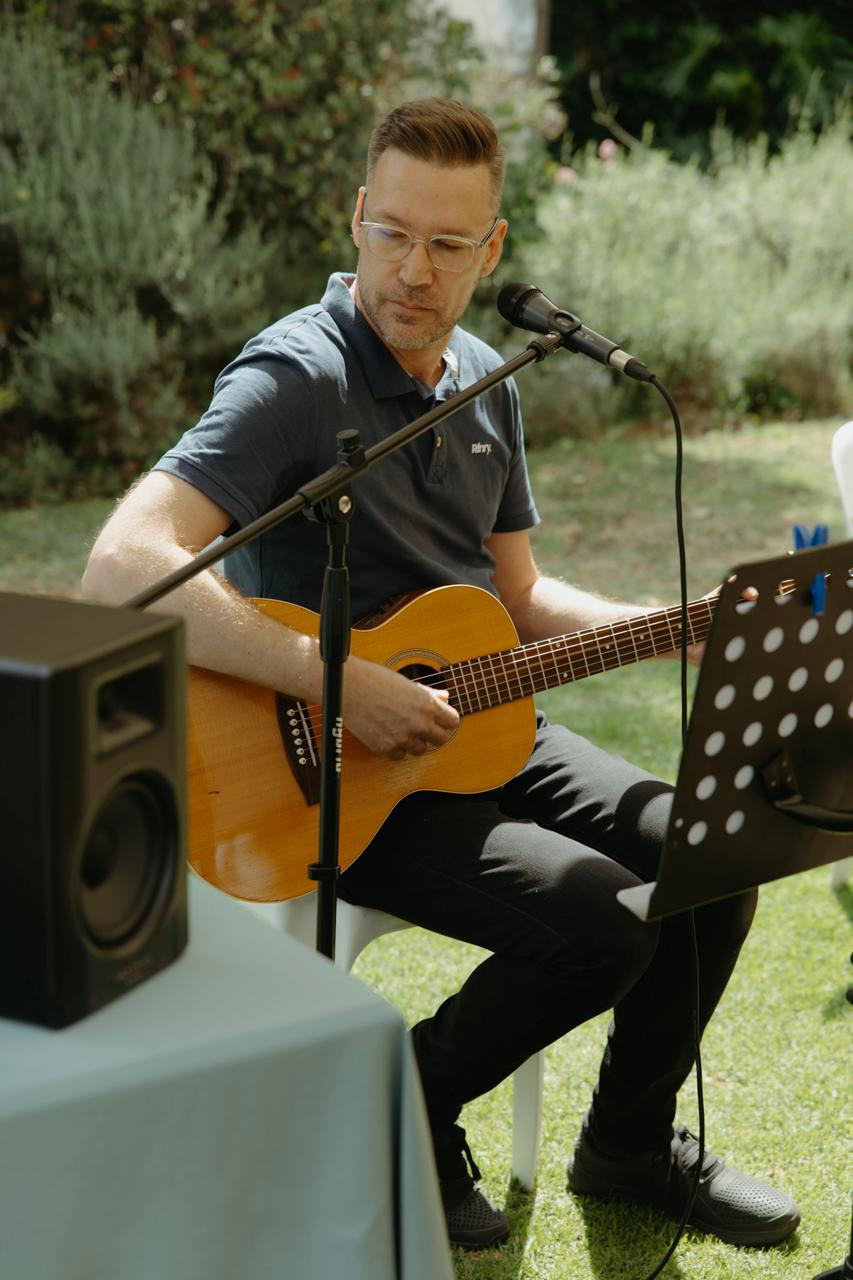 Johann van Brummelen, ProJo guitar teacher in Linden, Randburg, playing acoustic guitar outdoors